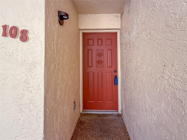 7500 40th Ave W Unit 108, Bradenton, FL 34209 - doorway to property with stucco siding