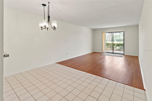 7500 40th Ave W Unit 108, Bradenton, FL 34209 - spare room with a chandelier, light wood-type flooring, and baseboards