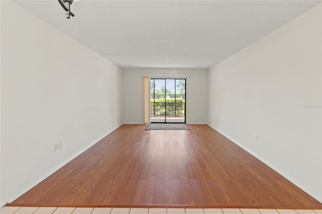 7500 40th Ave W Unit 108, Bradenton, FL 34209 - empty room with wood finished floors and baseboards