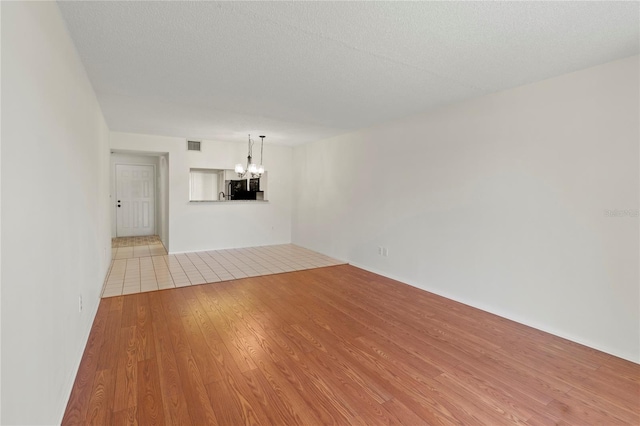 7500 40th Ave W Unit 108, Bradenton, FL 34209 - unfurnished living room with a chandelier and wood finished floors