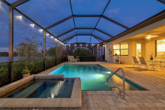 view of pool featuring a patio area, a pool with connected hot tub, a ceiling fan, and a lanai