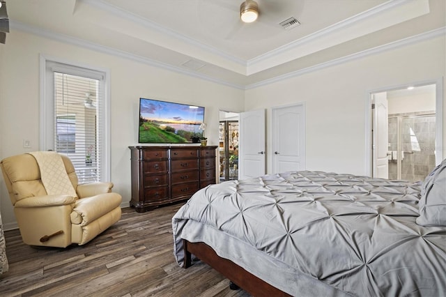 bedroom featuring a raised ceiling, wood finished floors, ornamental molding, and a ceiling fan