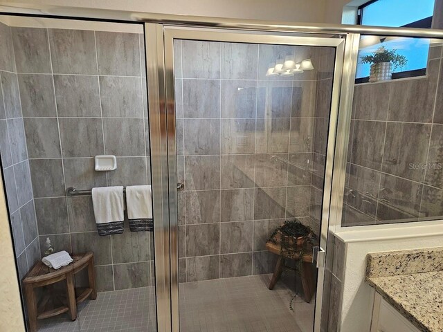 full bathroom with a stall shower and vanity