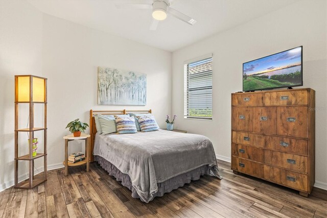 bedroom featuring hardwood / wood-style flooring, baseboards, and ceiling fan
