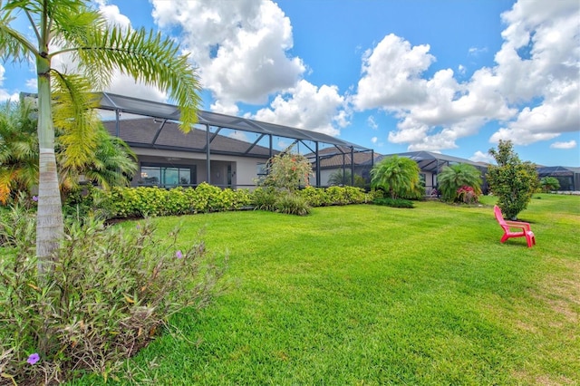 view of green lawn featuring a lanai