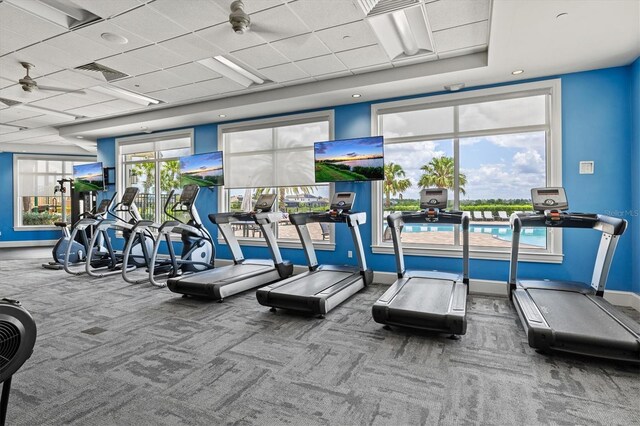 workout area featuring carpet floors and baseboards