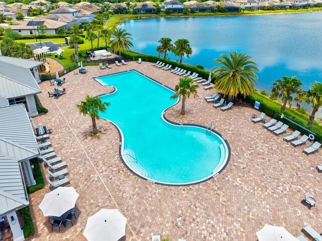 community pool with a water view and a residential view