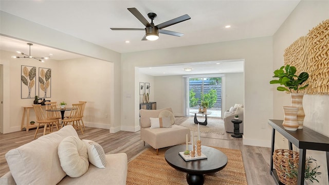 2825 Pinecrest St, Sarasota, FL 34239 - living area with light wood finished floors, a ceiling fan, recessed lighting, baseboards, and a chandelier