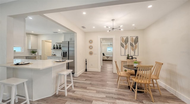 2825 Pinecrest St, Sarasota, FL 34239 - dining space featuring baseboards, light wood-type flooring, recessed lighting, and a chandelier