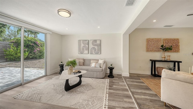 2825 Pinecrest St, Sarasota, FL 34239 - living room with baseboards, wood finished floors, and recessed lighting
