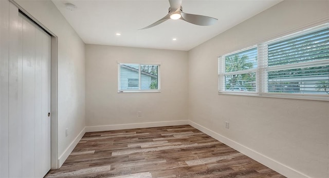 2825 Pinecrest St, Sarasota, FL 34239 - unfurnished bedroom with wood finished floors, a closet, baseboards, a ceiling fan, and recessed lighting