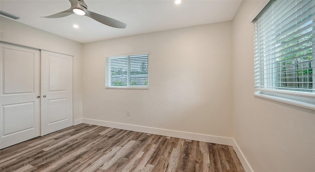 2825 Pinecrest St, Sarasota, FL 34239 - unfurnished bedroom with wood finished floors, a closet, baseboards, recessed lighting, and a ceiling fan