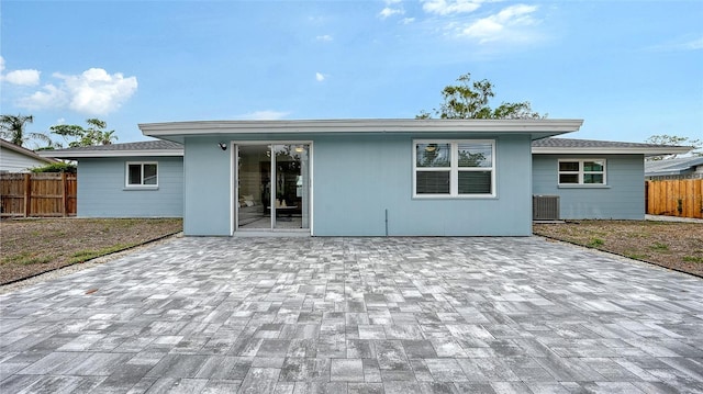 2825 Pinecrest St, Sarasota, FL 34239 - back of house with fence, a patio area, and central AC