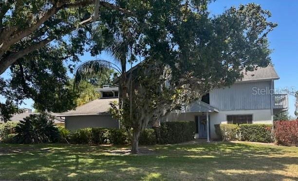 1212 Candlewood Dr, Lakeland, FL 33813 - rear view of property featuring a yard