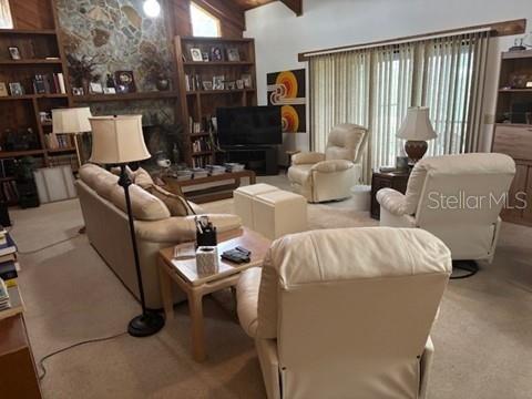 1212 Candlewood Dr, Lakeland, FL 33813 - living area featuring healthy amount of natural light, carpet, and beam ceiling