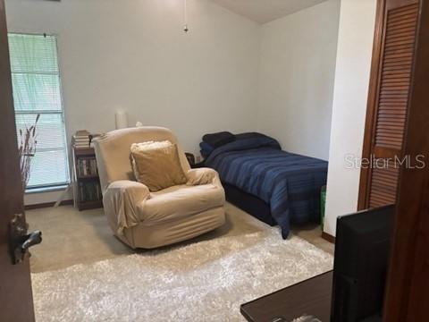 1212 Candlewood Dr, Lakeland, FL 33813 - bedroom featuring carpet floors and a baseboard radiator