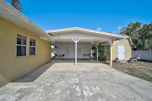 2708 27th Avenue Dr W, Bradenton, FL 34205 - view of vehicle parking featuring a carport, concrete driveway, and a shed