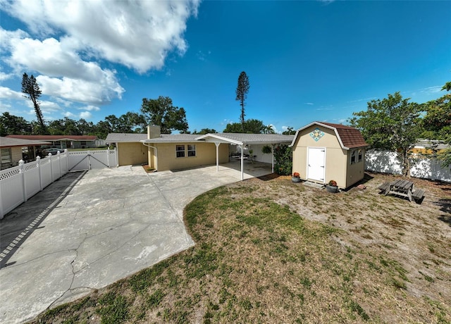 2708 27th Avenue Dr W, Bradenton, FL 34205 - back of property featuring a storage shed, a fenced backyard, a chimney, and a gate