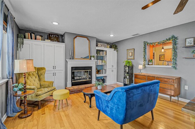 2708 27th Avenue Dr W, Bradenton, FL 34205 - living area with light wood-style flooring, a brick fireplace, recessed lighting, and ceiling fan