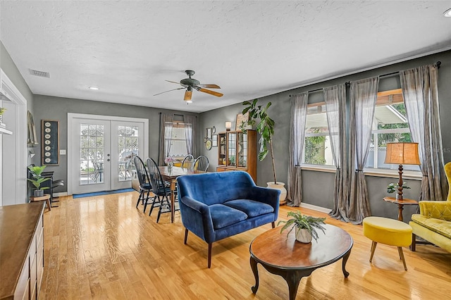 2708 27th Avenue Dr W, Bradenton, FL 34205 - living room featuring french doors, light wood-style flooring, plenty of natural light, a textured ceiling, and recessed lighting