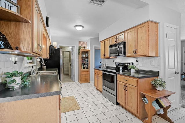 2708 27th Avenue Dr W, Bradenton, FL 34205 - kitchen with stainless steel electric range oven, open shelves, dark countertops, tasteful backsplash, and light tile patterned flooring