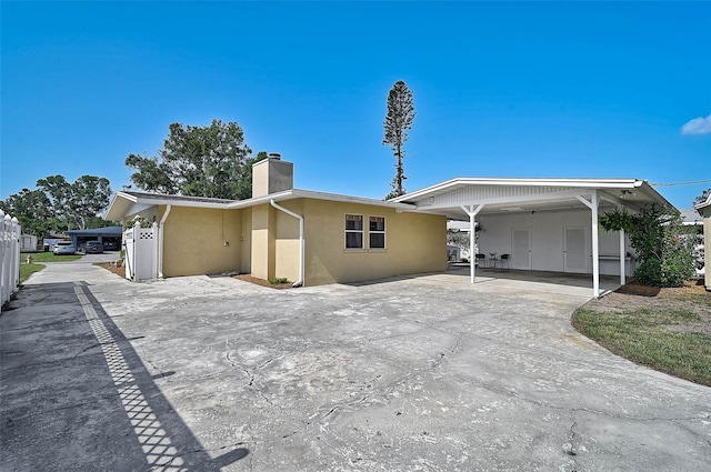 2708 27th Avenue Dr W, Bradenton, FL 34205 - ranch-style house featuring stucco siding, a chimney, and a carport