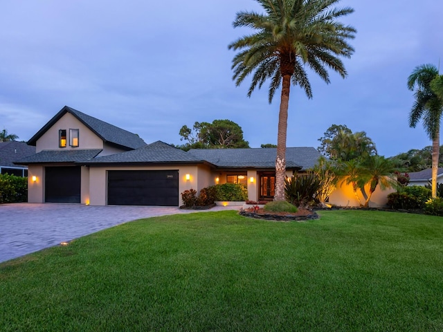 3905 Country View Dr, Sarasota, FL 34233 - view of front of property with a garage, a front lawn, stucco siding, and decorative driveway