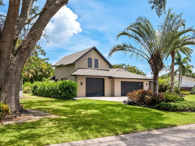 3905 Country View Dr, Sarasota, FL 34233 - view of front facade featuring stucco siding, an attached garage, a front yard, a shingled roof, and driveway