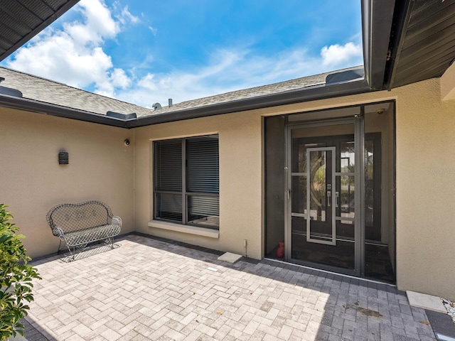 3905 Country View Dr, Sarasota, FL 34233 - view of exterior entry with a patio and stucco siding