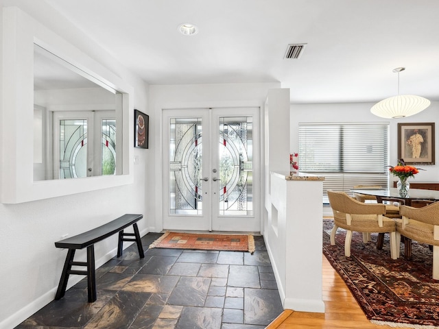 3905 Country View Dr, Sarasota, FL 34233 - entrance foyer with french doors, baseboards, and stone tile floors