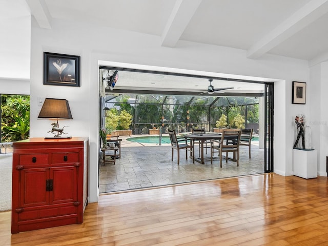 3905 Country View Dr, Sarasota, FL 34233 - dining area featuring beamed ceiling, a sunroom, wood finished floors, and ceiling fan