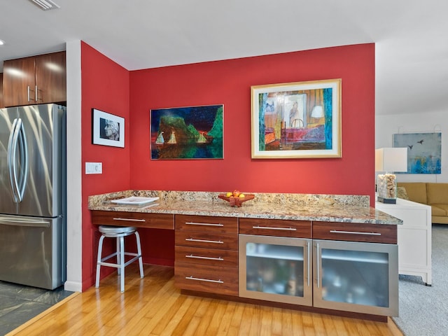 3905 Country View Dr, Sarasota, FL 34233 - bar area featuring freestanding refrigerator and light wood-style floors