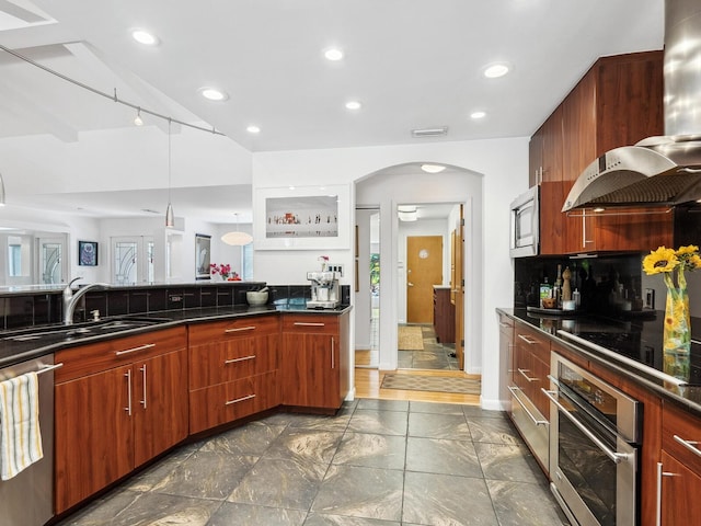 3905 Country View Dr, Sarasota, FL 34233 - kitchen featuring appliances with stainless steel finishes, a sink, arched walkways, dark countertops, and recessed lighting