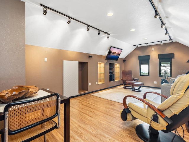 3905 Country View Dr, Sarasota, FL 34233 - interior space featuring rail lighting, wood finished floors, lofted ceiling, baseboards, and recessed lighting