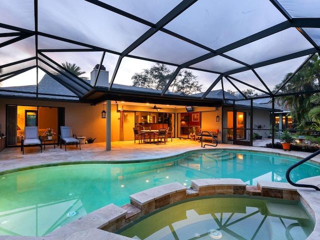 3905 Country View Dr, Sarasota, FL 34233 - view of pool with a pool with connected hot tub, a patio, outdoor dining area, and a lanai