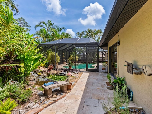 3905 Country View Dr, Sarasota, FL 34233 - view of patio / terrace with an outdoor pool and glass enclosure