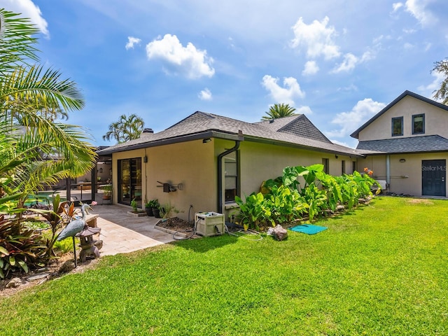 3905 Country View Dr, Sarasota, FL 34233 - back of house with stucco siding, a patio area, and a yard