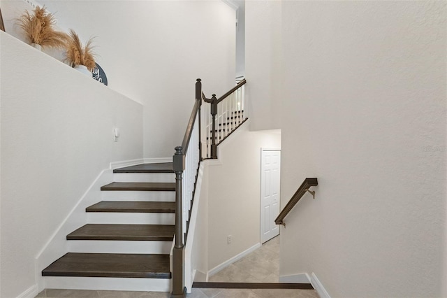 10820 Tarflower Dr Unit 202, Venice, FL 34293 - stairway featuring baseboards, a towering ceiling, and tile patterned floors