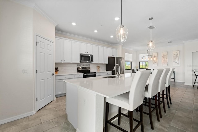 10820 Tarflower Dr Unit 202, Venice, FL 34293 - kitchen with appliances with stainless steel finishes, crown molding, a sink, a large island, and backsplash