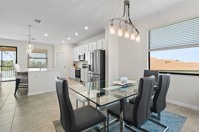 10820 Tarflower Dr Unit 202, Venice, FL 34293 - dining room with crown molding, recessed lighting, light tile patterned flooring, and baseboards