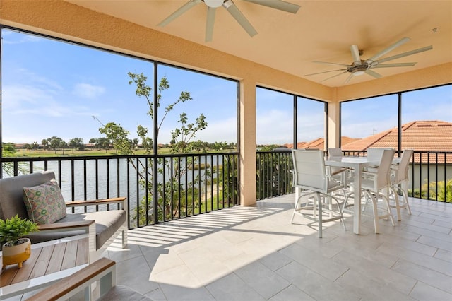 10820 Tarflower Dr Unit 202, Venice, FL 34293 - sunroom / solarium featuring a ceiling fan, a water view, and outdoor dining area