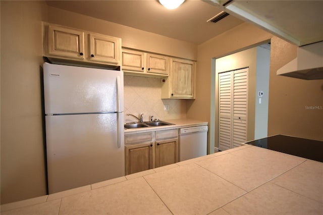 kitchen with white appliances, a sink, backsplash, tile countertops, and under cabinet range hood