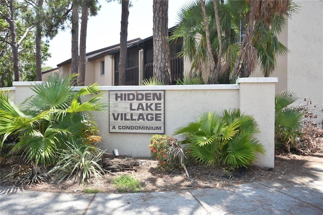 community / neighborhood sign featuring fence