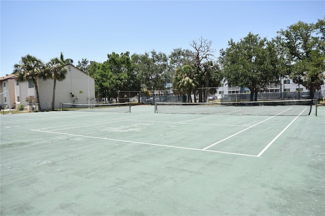 view of tennis court with fence