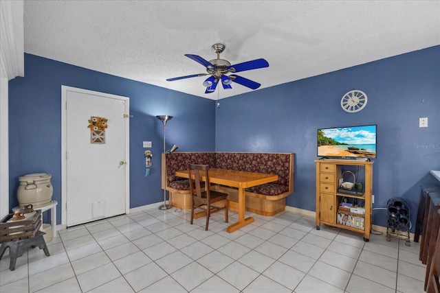 6207 Courtside Dr Unit 23, Bradenton, FL 34210 - dining room featuring ceiling fan, baseboards, and a textured ceiling