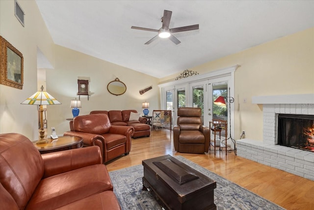 6207 Courtside Dr Unit 23, Bradenton, FL 34210 - living area featuring lofted ceiling, a ceiling fan, wood finished floors, and a fireplace