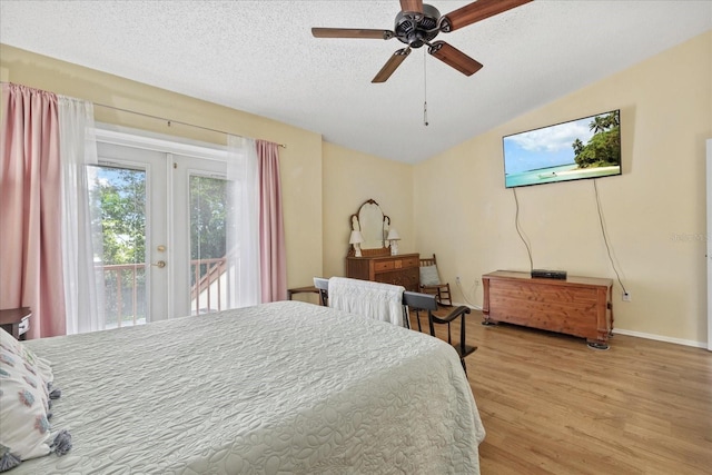 6207 Courtside Dr Unit 23, Bradenton, FL 34210 - bedroom featuring access to exterior, light wood finished floors, vaulted ceiling, a textured ceiling, and baseboards