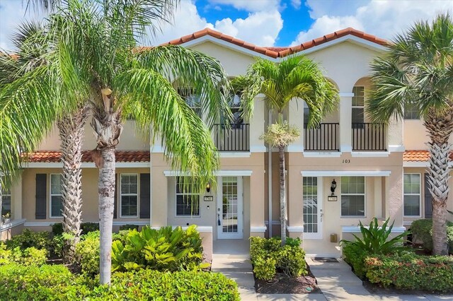 3760 82nd Avenue Cir E Unit 102, Sarasota, FL 34243 - view of front facade with a tiled roof and stucco siding