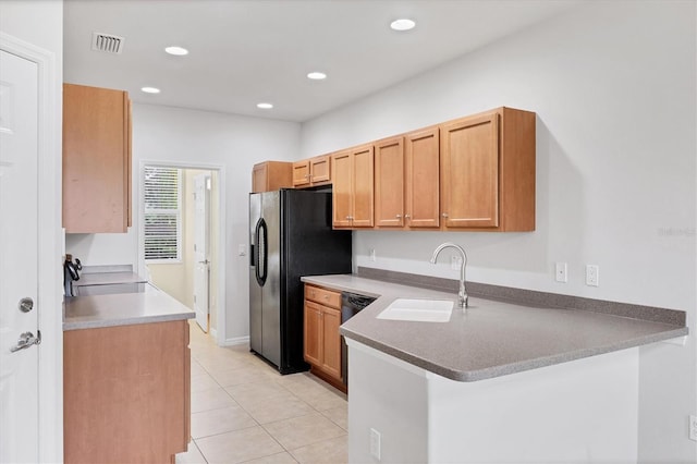 3760 82nd Avenue Cir E Unit 102, Sarasota, FL 34243 - kitchen with a sink, a peninsula, light tile patterned floors, black appliances, and recessed lighting