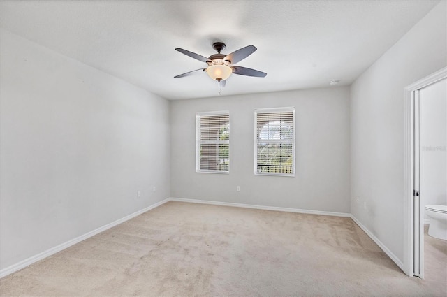 3760 82nd Avenue Cir E Unit 102, Sarasota, FL 34243 - empty room with light colored carpet, ceiling fan, and baseboards